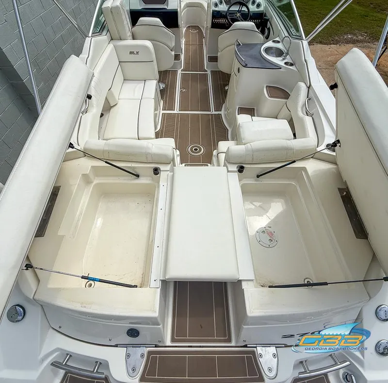 Slide: The Image of 2008 Sea Ray 270 SLX boat interior with white seating and brown flooring. - 44