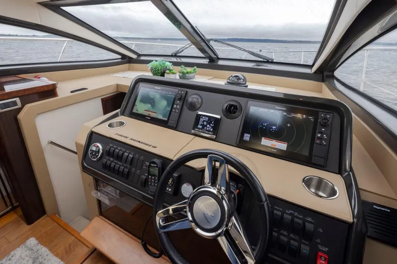 Slide: The Image of Helm of 2016 Sea Ray 400 Sundancer yacht with modern navigation equipment. - 16