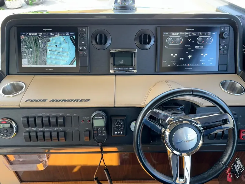 Slide: The Image of Dashboard of a 2016 Sea Ray 400 Sundancer with navigation and control systems. - 17