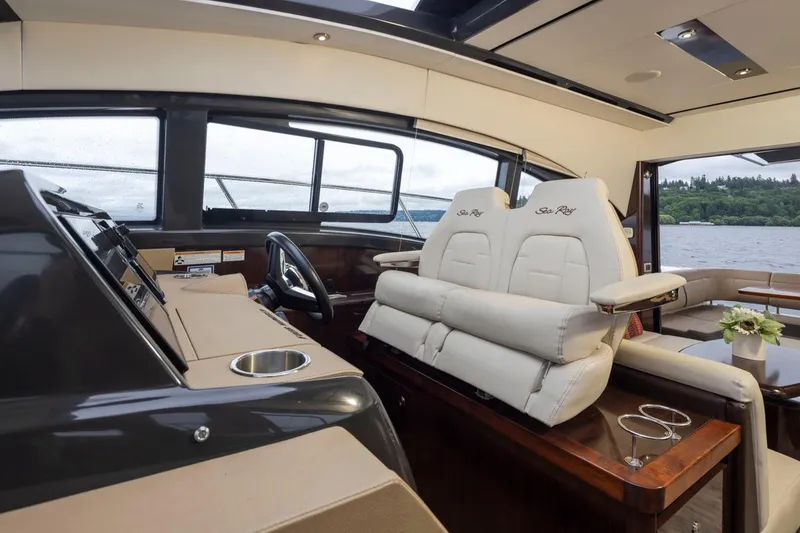 Slide: The Image of Interior of 2016 Sea Ray 400 Sundancer yacht with luxurious seating and helm. - 20