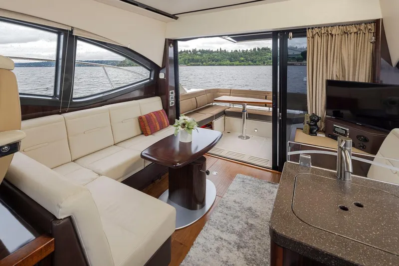 Slide: The Image of Luxurious interior of 2016 Sea Ray 400 Sundancer yacht with elegant seating and scenic water view. - 22