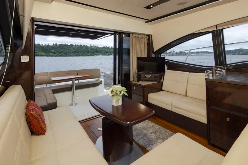 Slide: The Image of Luxurious interior of 2016 Sea Ray 400 Sundancer yacht with elegant seating and scenic water view. - 23