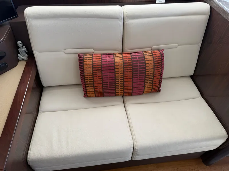 Slide: The Image of Beige seating with a colorful cushion on a 2016 Sea Ray 400 Sundancer yacht. - 27