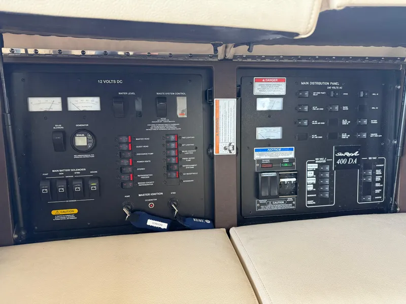 Slide: The Image of Control panel of a 2016 Sea Ray 400 Sundancer boat, featuring various switches and gauges. - 28