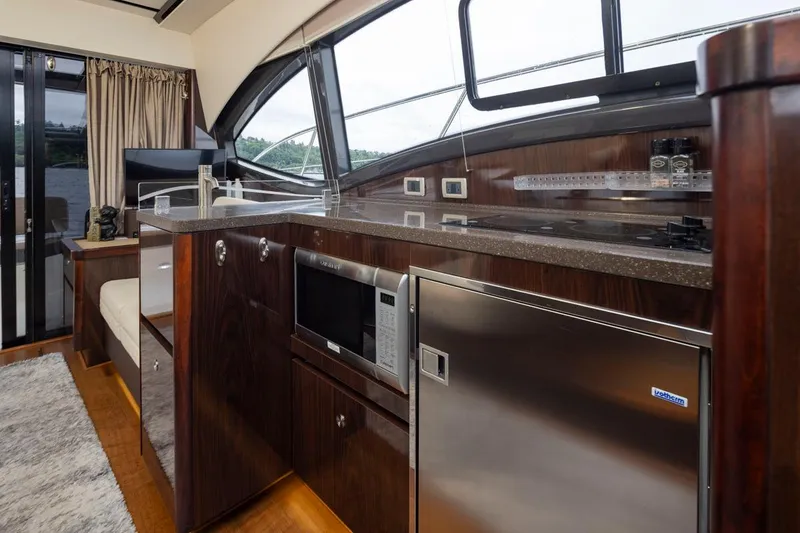 Slide: The Image of Luxurious interior of 2016 Sea Ray 400 Sundancer yacht with modern kitchen amenities. - 31