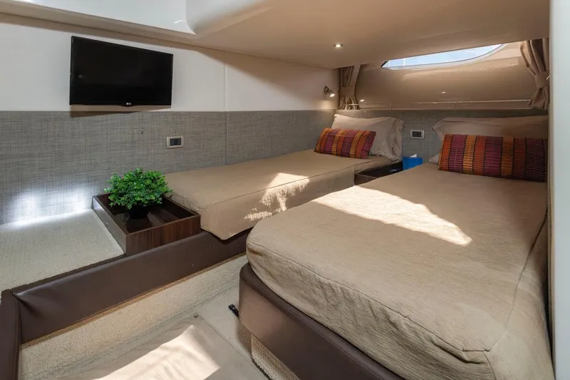 Slide: The Image of Interior of 2016 Sea Ray 400 Sundancer with twin beds and modern decor. - 38