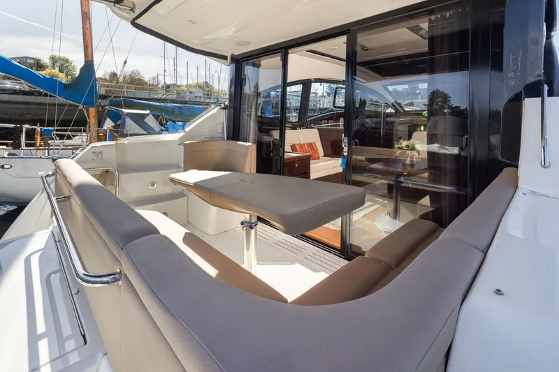 Slide: The Image of 2016 Sea Ray 400 Sundancer yacht with elegant outdoor seating and table. - 42