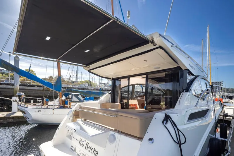 Slide: The Image of 2016 Sea Ray 400 Sundancer yacht docked at marina, featuring spacious deck and modern design. - 43