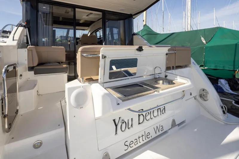Slide: The Image of 2016 Sea Ray 400 Sundancer yacht with outdoor seating and grill, docked in Seattle. - 45