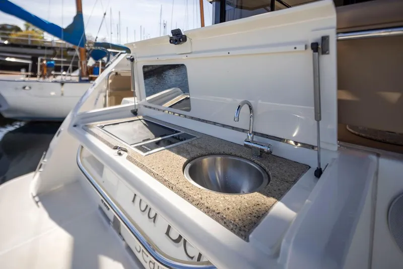 Slide: The Image of Outdoor kitchenette on 2016 Sea Ray 400 Sundancer yacht with sink and counter. - 46