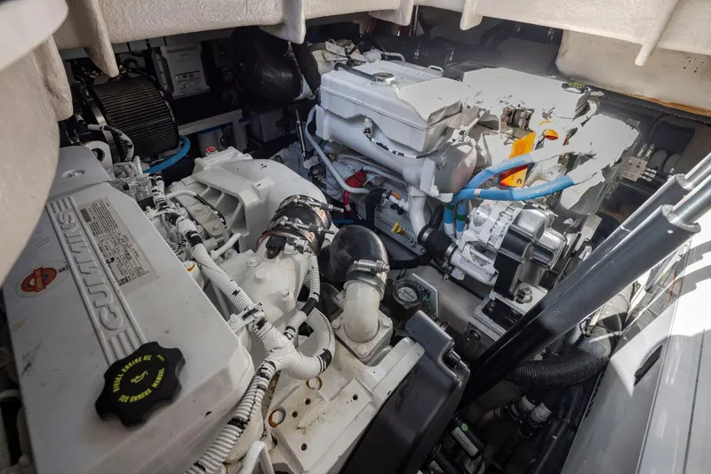 Slide: The Image of Engine room of a 2016 Sea Ray 400 Sundancer, featuring Cummins engines. - 48