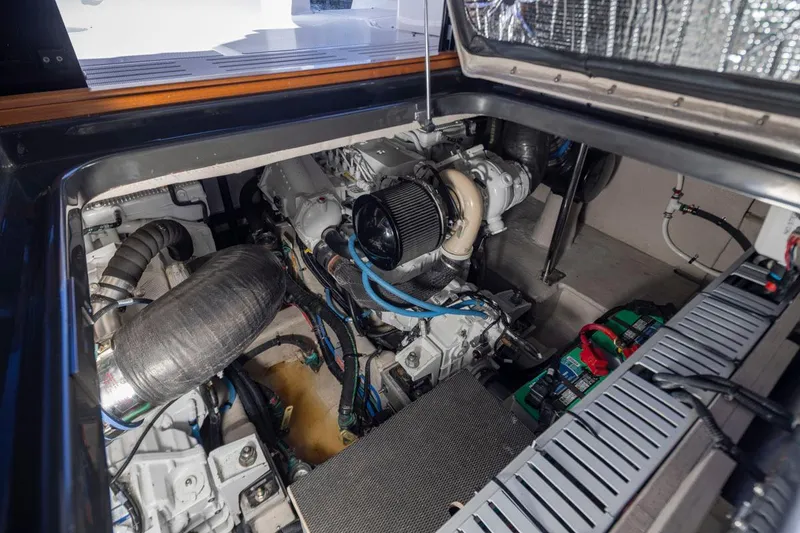 Slide: The Image of Engine compartment of a 2016 Sea Ray 400 Sundancer yacht, showcasing mechanical components. - 49