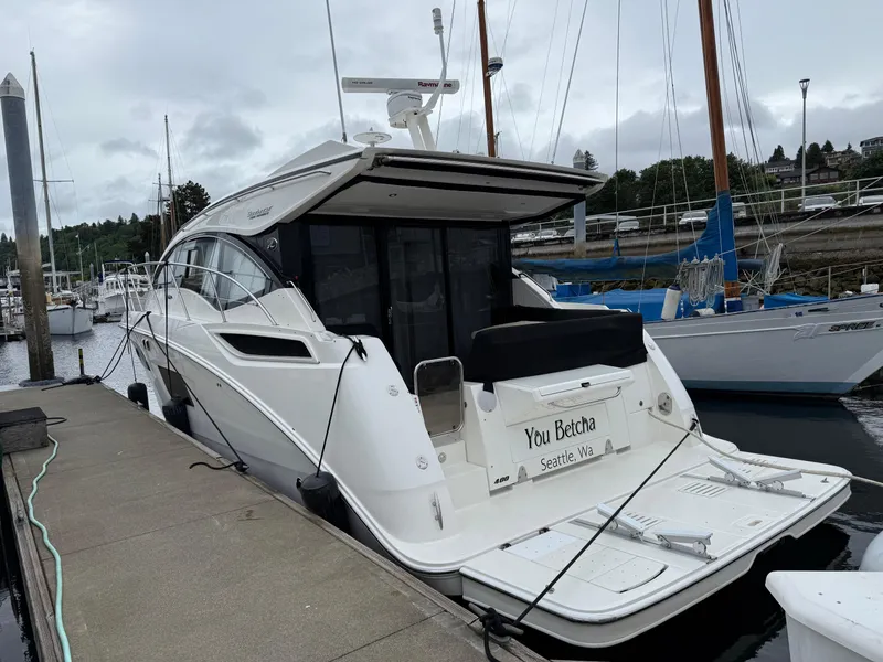 Slide: The Image of 2016 Sea Ray 400 Sundancer yacht docked at marina, rear view. - 52