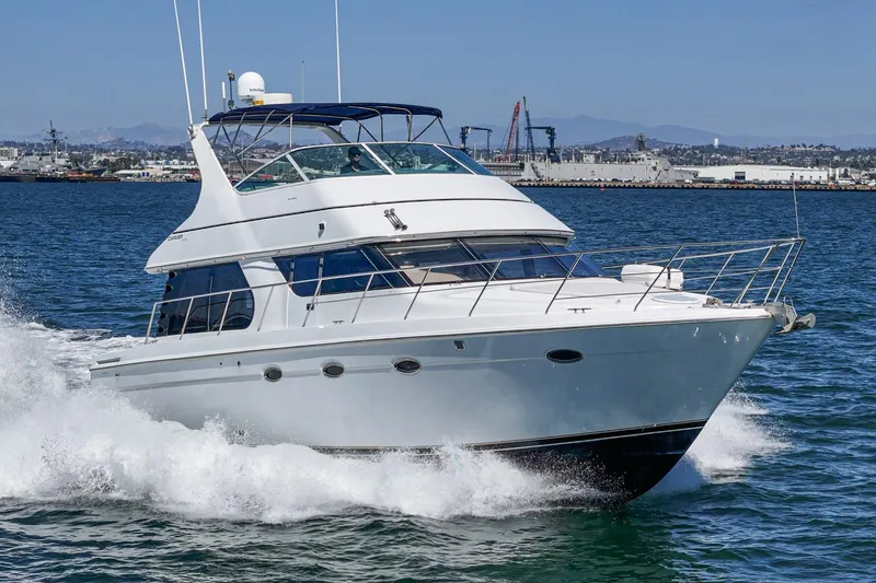 Slide: The Image of 2000 Carver 450 Voyager Pilothouse yacht cruising on open water. - 13