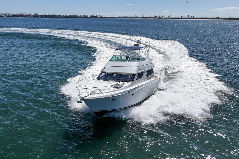 Slide: The Image of 2000 Carver 450 Voyager Pilothouse yacht cruising on open water. - 15