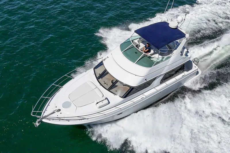 Slide: The Image of 2000 Carver 450 Voyager Pilothouse yacht cruising on open water. - 18