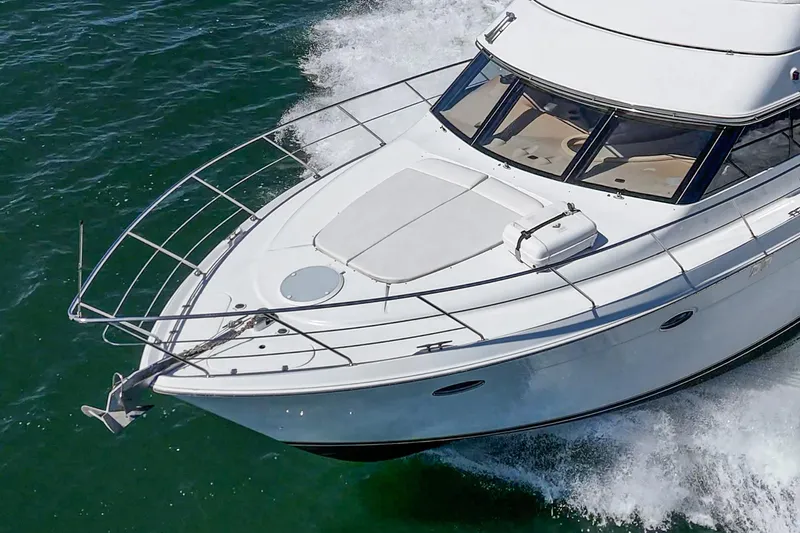 Slide: The Image of 2000 Carver 450 Voyager Pilothouse cruising on open water. - 19