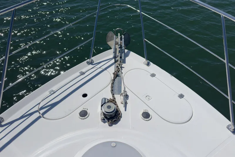 Slide: The Image of Bow of 2000 Carver 450 Voyager Pilothouse with anchor and railing over water. - 20