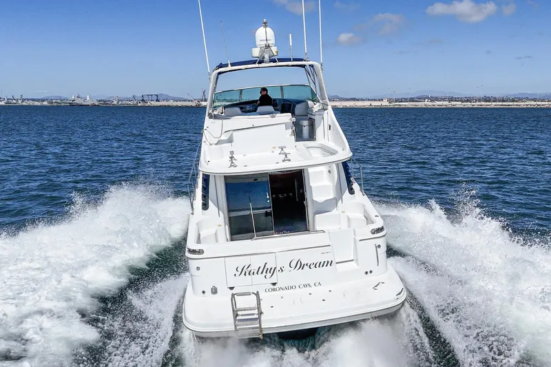 Slide: The Image of 2000 Carver 450 Voyager Pilothouse cruising on open water, rear view. - 24