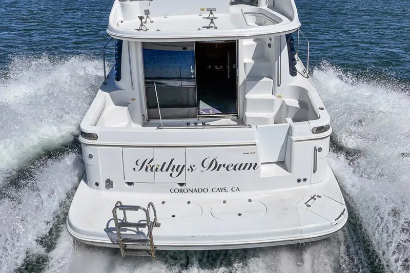 Slide: The Image of Carver 450 Voyager Pilothouse yacht cruising, rear view, named "Kathy's Dream," 2000 model. - 25