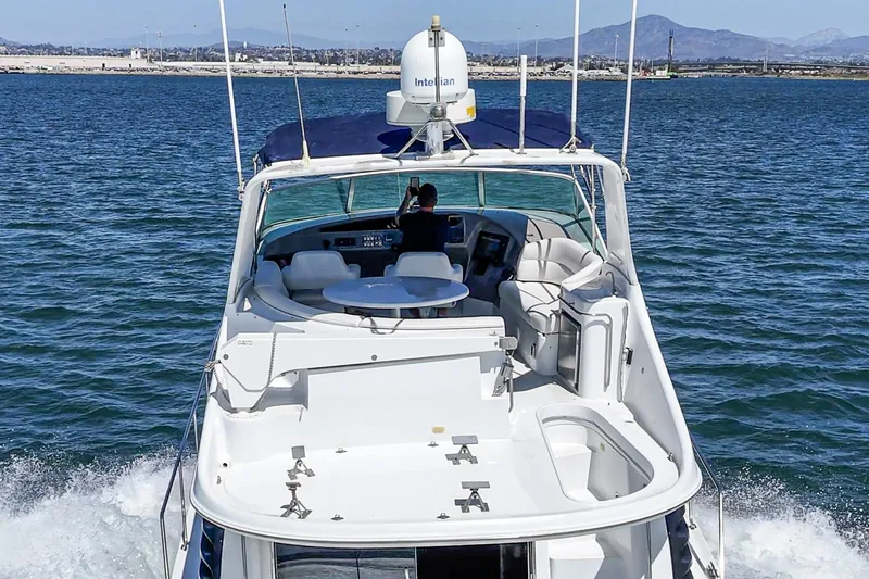 Slide: The Image of 2000 Carver 450 Voyager Pilothouse cruising on open water, rear view. - 26