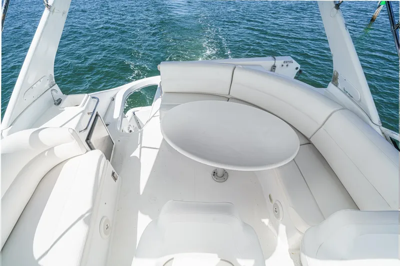 Slide: The Image of 2000 Carver 450 Voyager Pilothouse yacht with white seating and table on deck. - 27