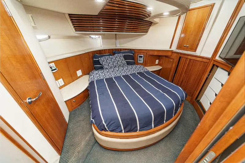 Slide: The Image of Luxurious cabin interior of 2000 Carver 450 Voyager Pilothouse with cozy bed and wood accents. - 3
