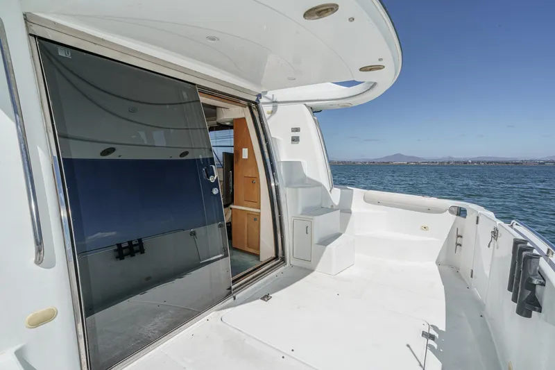 Slide: The Image of 2000 Carver 450 Voyager Pilothouse yacht deck with sliding glass door, ocean view. - 35