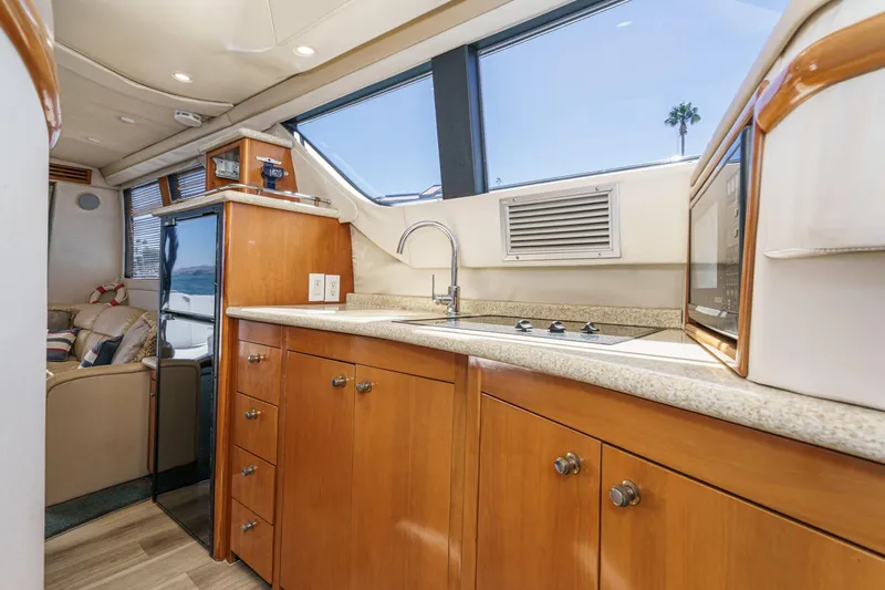 Slide: The Image of Interior of 2000 Carver 450 Voyager Pilothouse with modern kitchen amenities. - 4