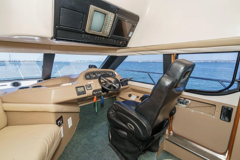 Slide: The Image of Interior of 2000 Carver 450 Voyager Pilothouse with steering wheel and navigation equipment. - 46