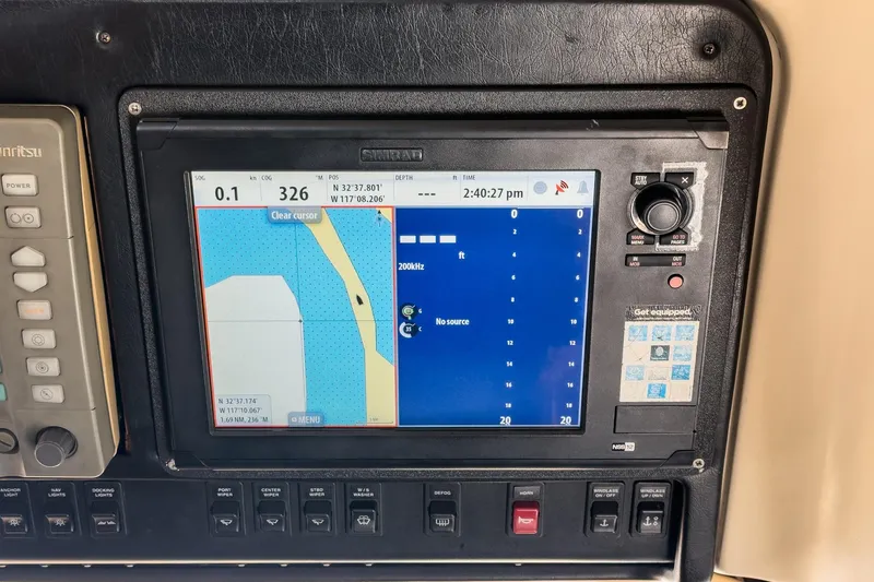 Slide: The Image of Navigation system on a 2000 Carver 450 Voyager Pilothouse boat dashboard. - 48