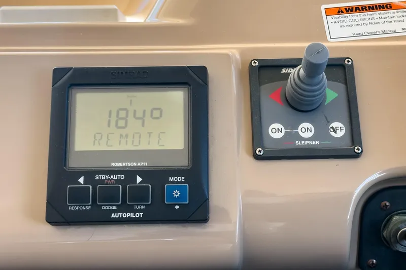 Slide: The Image of Autopilot controls on 2000 Carver 450 Voyager Pilothouse, featuring Simrad Robertson AP11. - 49