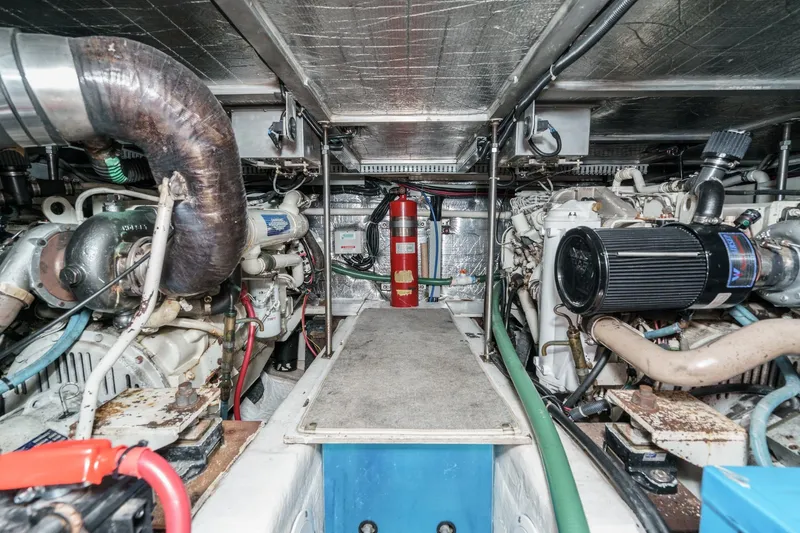 Slide: The Image of Engine room of 2000 Carver 450 Voyager Pilothouse with visible machinery and fire extinguisher. - 5
