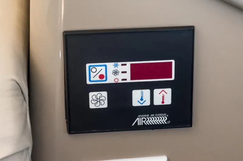 Slide: The Image of Control panel of a 2000 Carver 450 Voyager Pilothouse boat, featuring temperature and fan settings. - 50