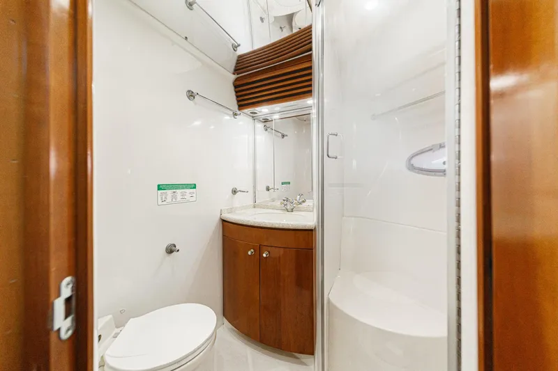 Slide: The Image of Luxurious bathroom in 2000 Carver 450 Voyager Pilothouse yacht, featuring modern fixtures and wood accents. - 55
