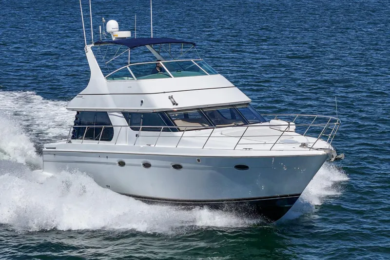 Slide: The Image of 2000 Carver 450 Voyager Pilothouse cruising on open water. - 6
