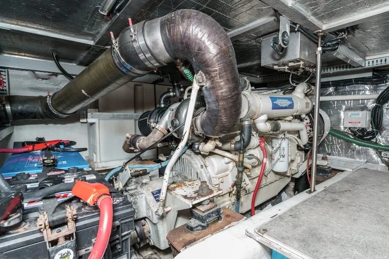Slide: The Image of Engine room of 2000 Carver 450 Voyager Pilothouse with visible machinery and components. - 62