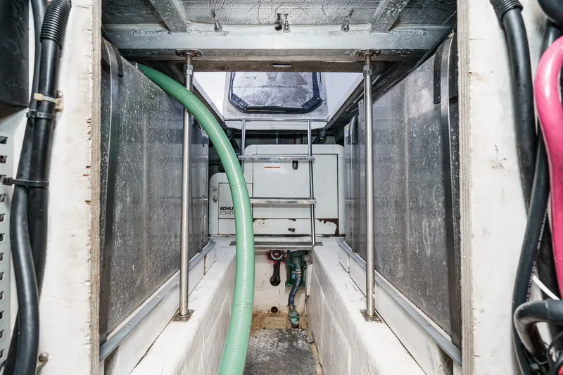 Slide: The Image of Engine room of 2000 Carver 450 Voyager Pilothouse with Kohler generator and hoses. - 63