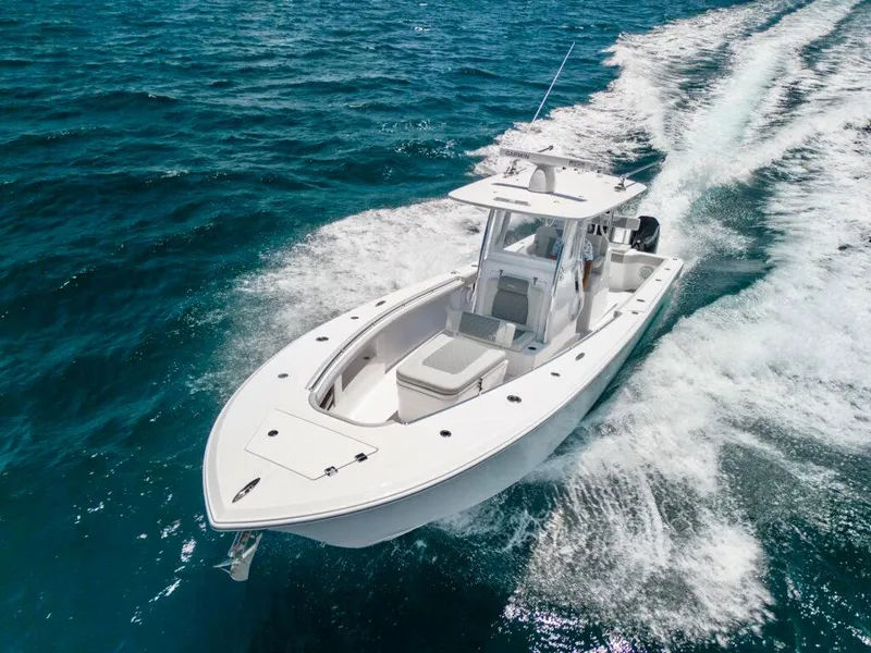 Slide: The Image of 2026 Front Runner 33 Center Console boat cruising on open blue water. - 1