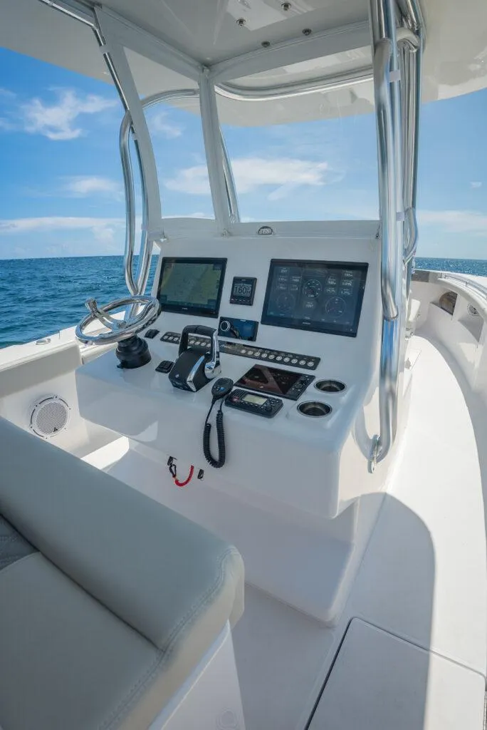Slide: The Image of 2026 Front Runner 33 Center Console boat dashboard with modern navigation equipment on open sea. - 13