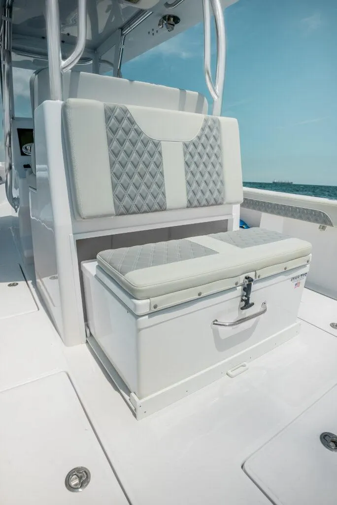 Slide: The Image of 2026 Front Runner 33 Center Console boat interior with cushioned seating and storage. - 9