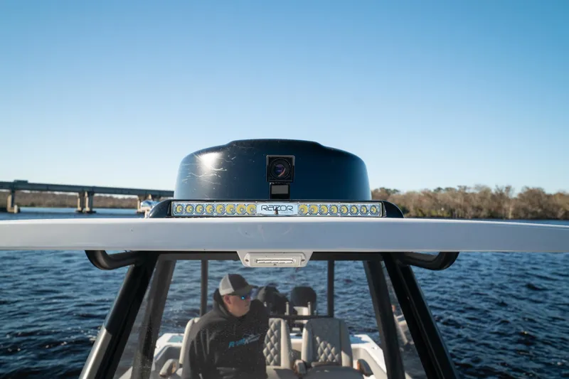 Slide: The Image of 2026 Front Runner 36 Center Console boat on water, featuring advanced navigation equipment. - 10