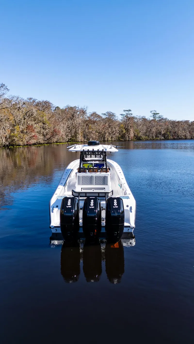 Slide: The Image of 2026 Front Runner 36 Center Console boat on a calm lake with clear blue sky. - 3