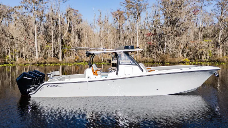 Slide: The Image of 2026 Front Runner 36 Center Console boat on calm water, surrounded by trees. - 5