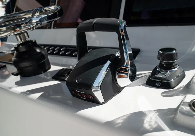 Slide: The Image of Control panel of 2026 Front Runner 37 Catamaran with steering wheel and throttle. - 12