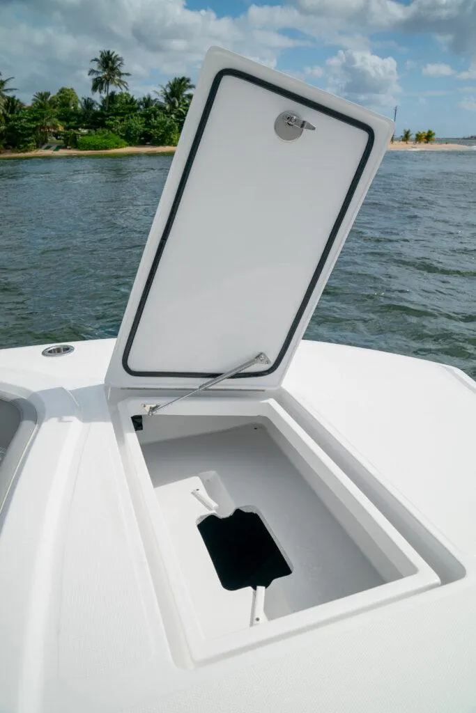 Slide: The Image of 2026 Front Runner 37 Catamaran storage compartment open on deck, near scenic shoreline. - 18