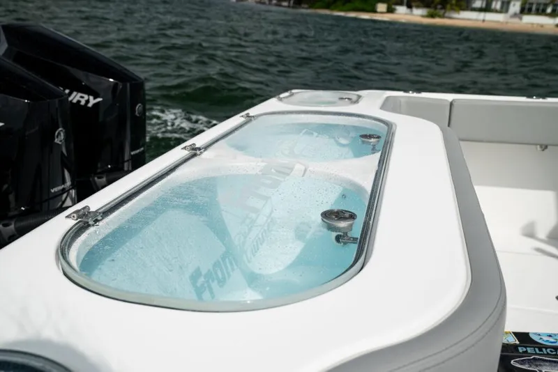 Slide: The Image of 2026 Front Runner 37 Catamaran with livewell, featuring dual Mercury engines on a lake. - 19