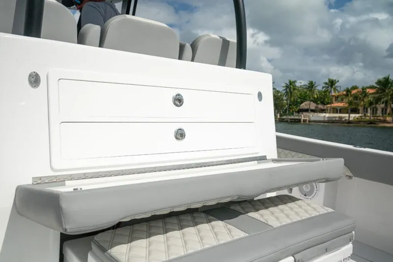 Slide: The Image of 2026 Front Runner 37 Catamaran interior seating and storage, featuring sleek design and coastal backdrop. - 23