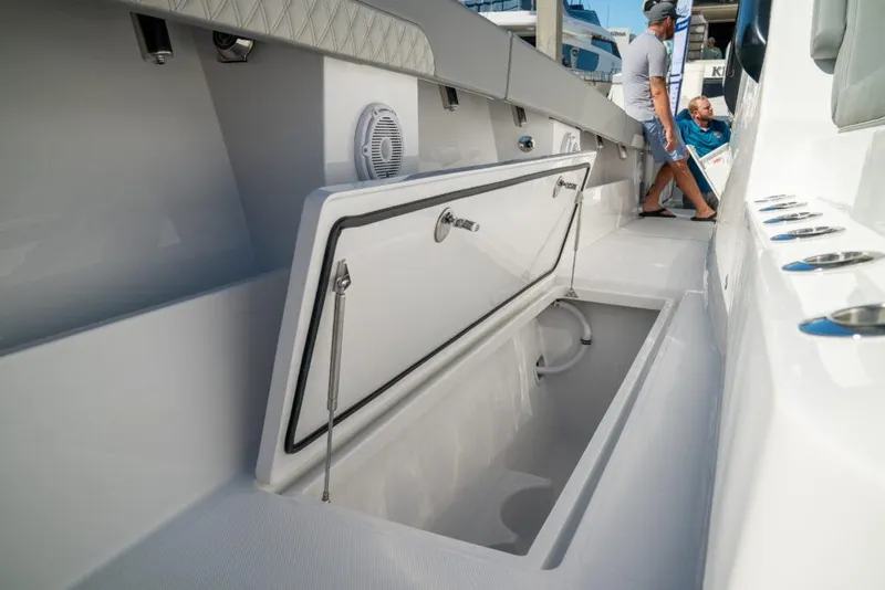 Slide: The Image of 2026 Front Runner 37 Catamaran deck with open storage compartment and seating area. - 9