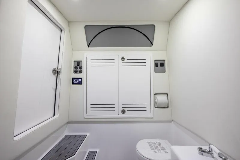 Slide: The Image of Interior of 2026 Front Runner 39 Center Console boat bathroom, featuring modern fixtures and storage. - 16